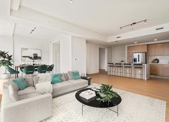 A modern living room with a white sofa and a coffee table.