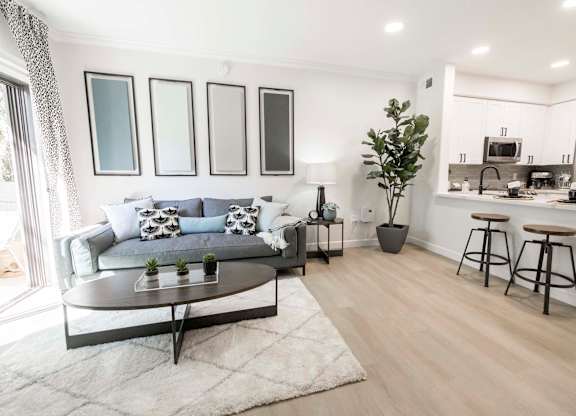 A modern living room with a grey sofa and a coffee table.