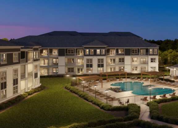 A resort with a swimming pool surrounded by buildings.