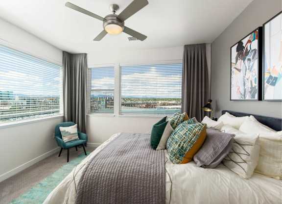 A bedroom with a large bed and a ceiling fan.