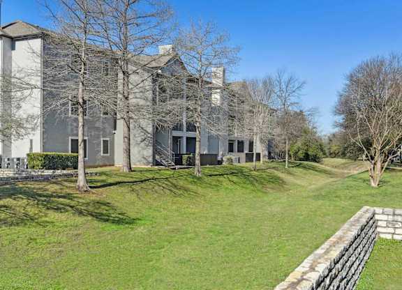 A large building with a grassy area in front of it.