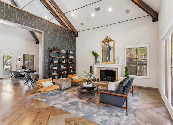 A living room with a fireplace and a mirror on the wall.