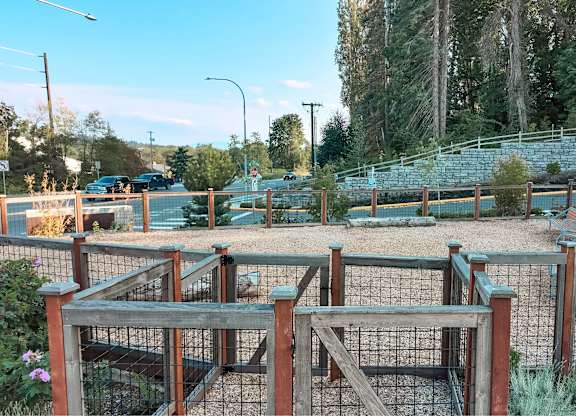 A playground with a wooden structure and a fence.