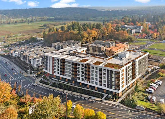 A large building with a parking lot in front of it.
