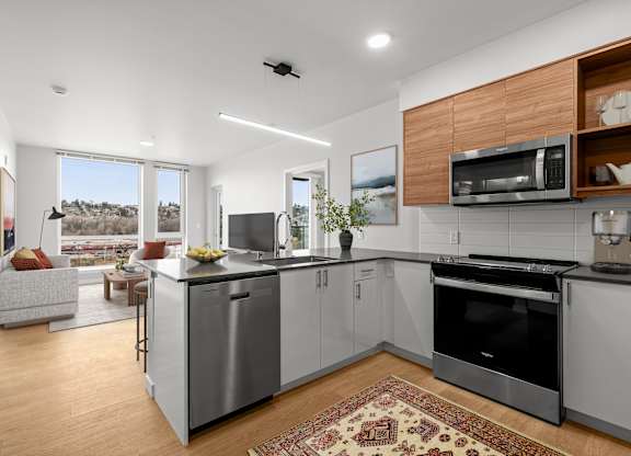 A modern kitchen with a large island and stainless steel appliances.