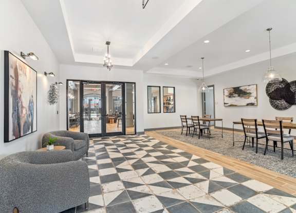 A black and white checkered floor in a room with a dining table and chairs.