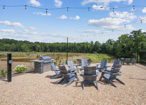 A set of chairs are arranged on a gravel area.