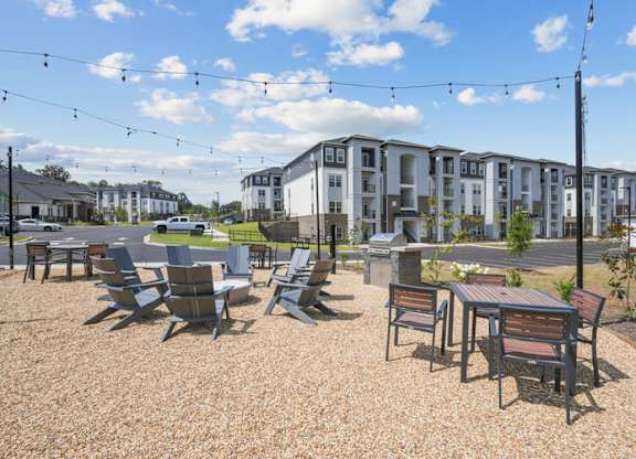 A sunny day at a gravel outdoor seating area with chairs and tables.