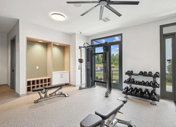 A spacious home gym with a treadmill, weights, and exercise equipment.