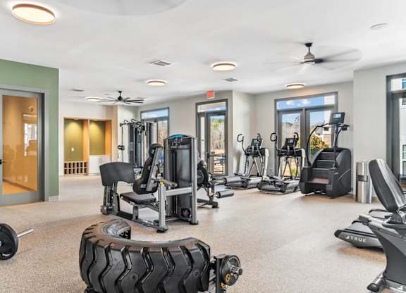 A spacious gym with a variety of equipment including treadmills, weights, and exercise machines.