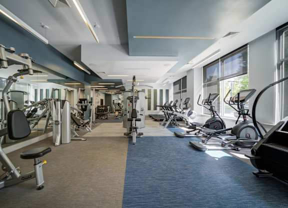 A gym with a variety of exercise equipment.