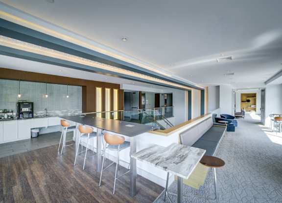 A modern kitchen with a long table and chairs.