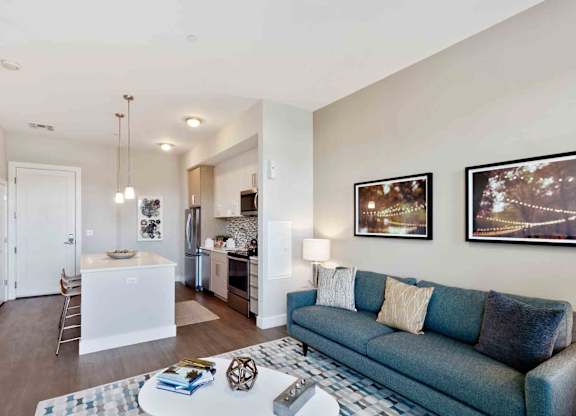 A living room with a blue couch and a coffee table.