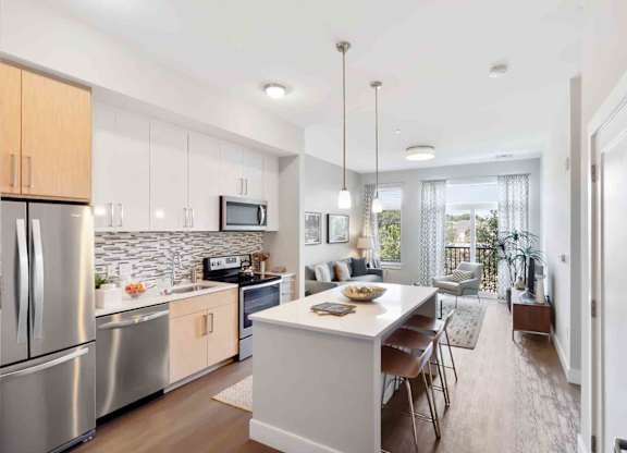 A modern kitchen with stainless steel appliances and wooden cabinets.