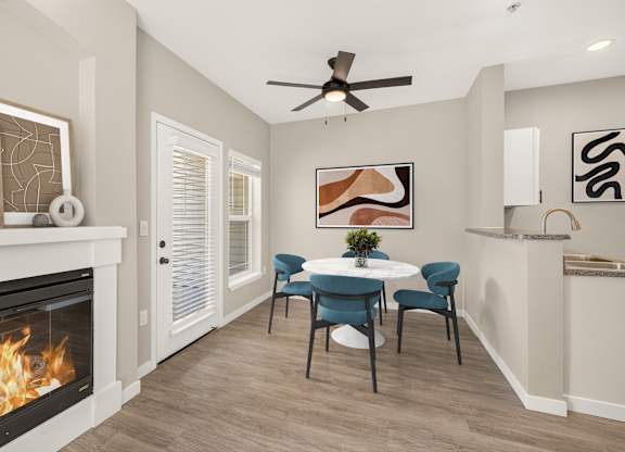 A modern living room with a fireplace and a dining table set up.