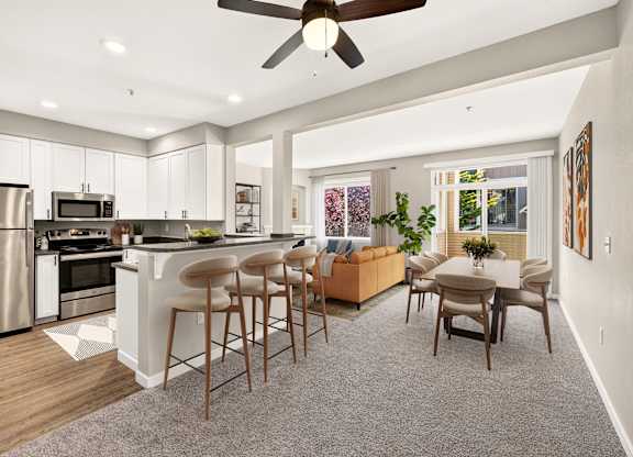 A modern kitchen with a bar area and a dining table.
