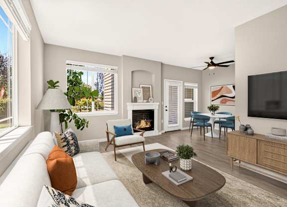 A living room with a fireplace, a couch, a chair, a coffee table, and a television.