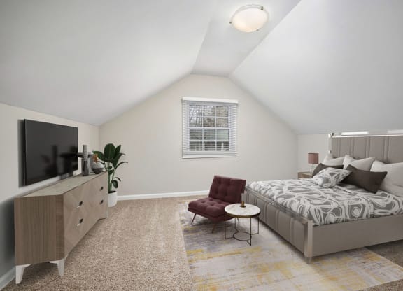 a bedroom with a bed and a dresser and a tv