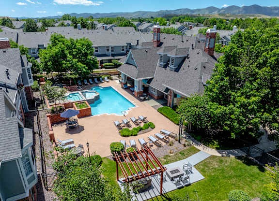 A large backyard with a pool and a deck.