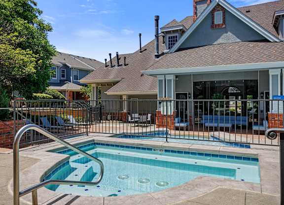A pool in a backyard with a slide.
