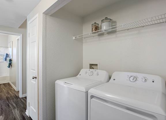 A small laundry room with a washer and dryer.