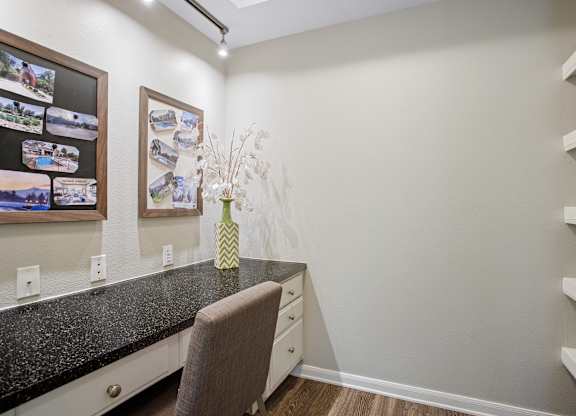 A kitchen with a granite countertop and a chair.