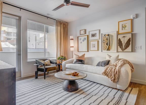 a living room with a couch and a ceiling fan