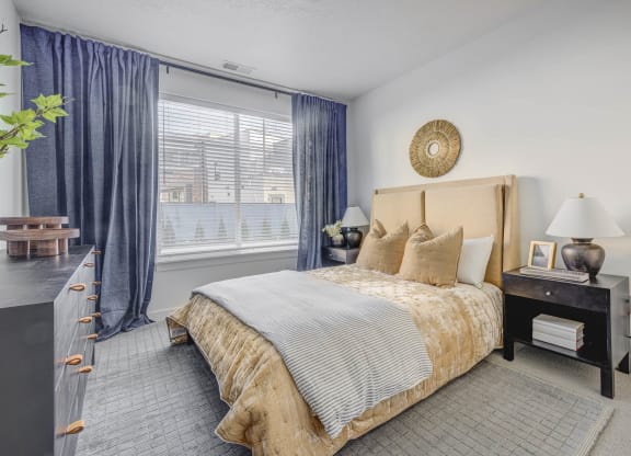 a bedroom with a large bed and a large window