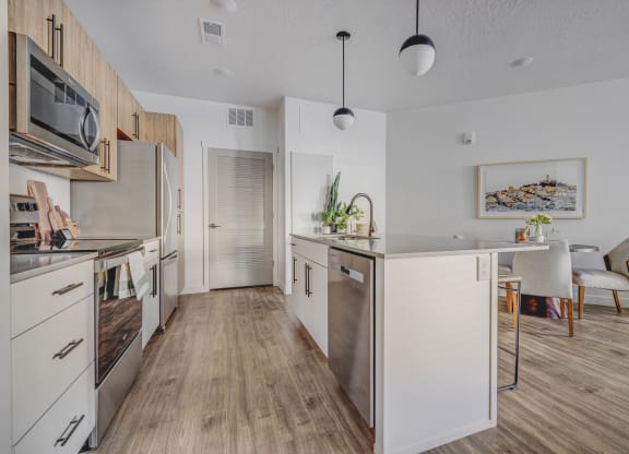 a kitchen with white cabinets and stainless steel appliances