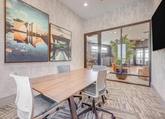 a conference room with a wooden table and chairs