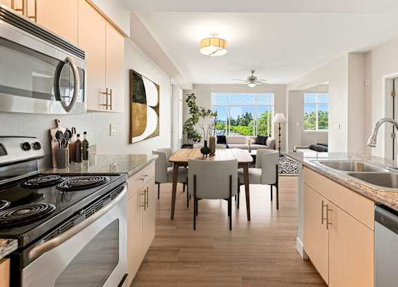 A modern kitchen with a dining table and chairs.