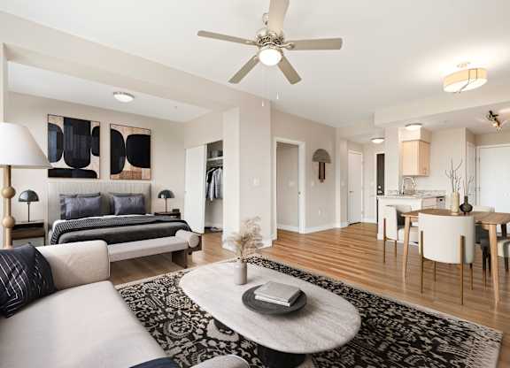 A modern living room with a white sofa and a black and white rug.