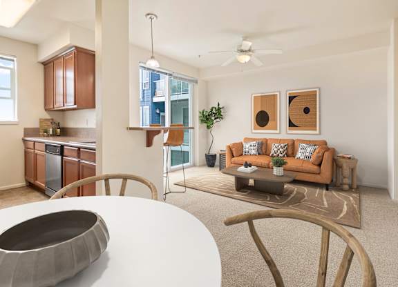 A modern living room with a white table and a brown couch.