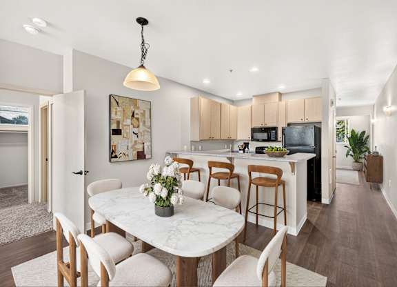 A modern kitchen with a dining table set for four.