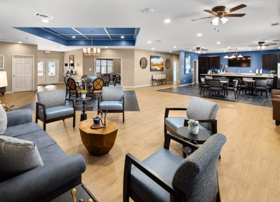 a large living room with couches and chairs and a dining room with a bar