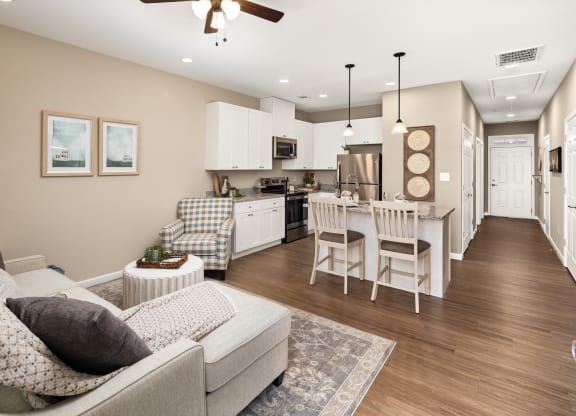 a living room and kitchen with a couch and a table