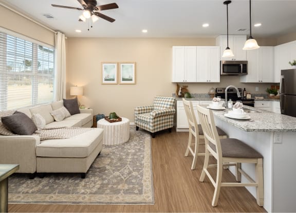 a living room and kitchen with a couch and a table