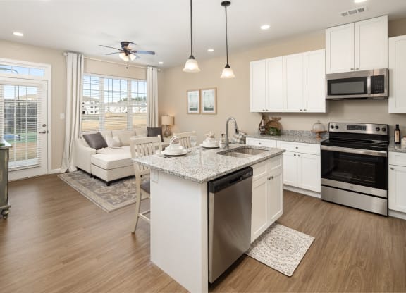 a kitchen with an island and a living room with a couch