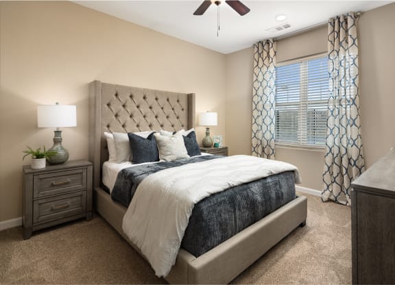 a bedroom with a bed and a ceiling fan