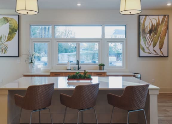 a kitchen with a large window and a table with four chairs