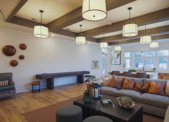 a living room with a large couch and a pool table
