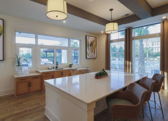 a kitchen with a large island and windows