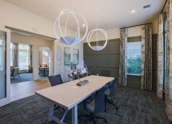 a conference room with a long wooden table and blue chairs
