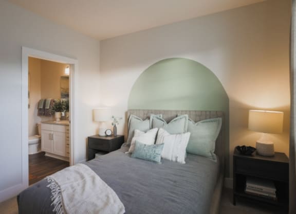 a bedroom with a bed and two nightstands