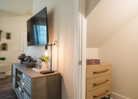 a bedroom with a dresser and television