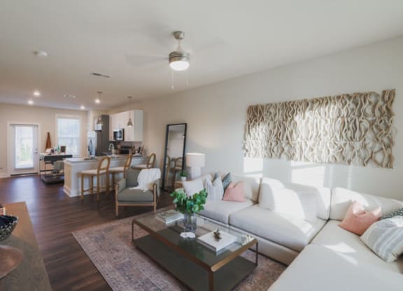 a living room with white couches and a coffee table