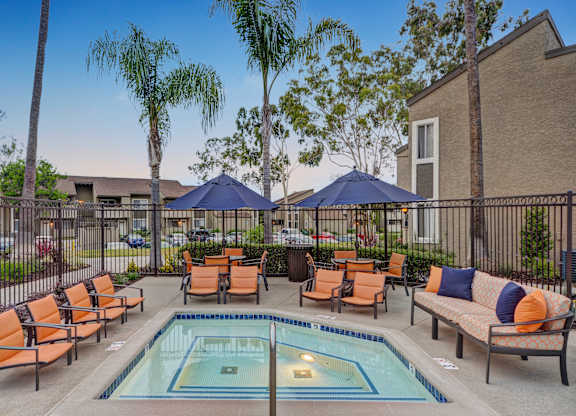 A pool surrounded by chairs and umbrellas.