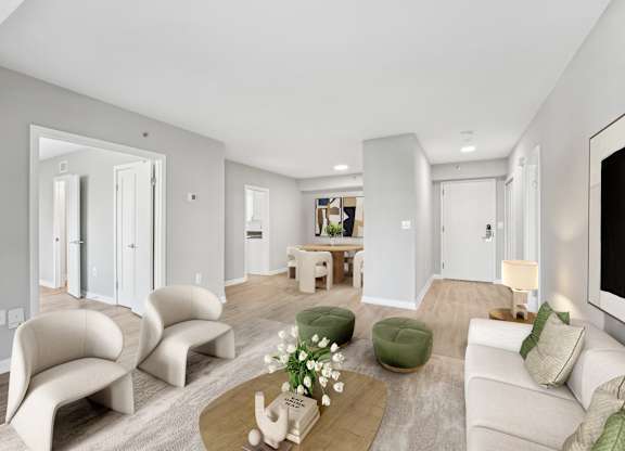 a living room with white furniture and a tv