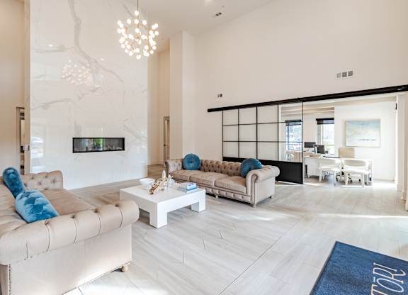 A modern living room with a large couch and a television.