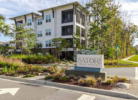 A Satori West Ashley apartment complex is shown with a sign in front.